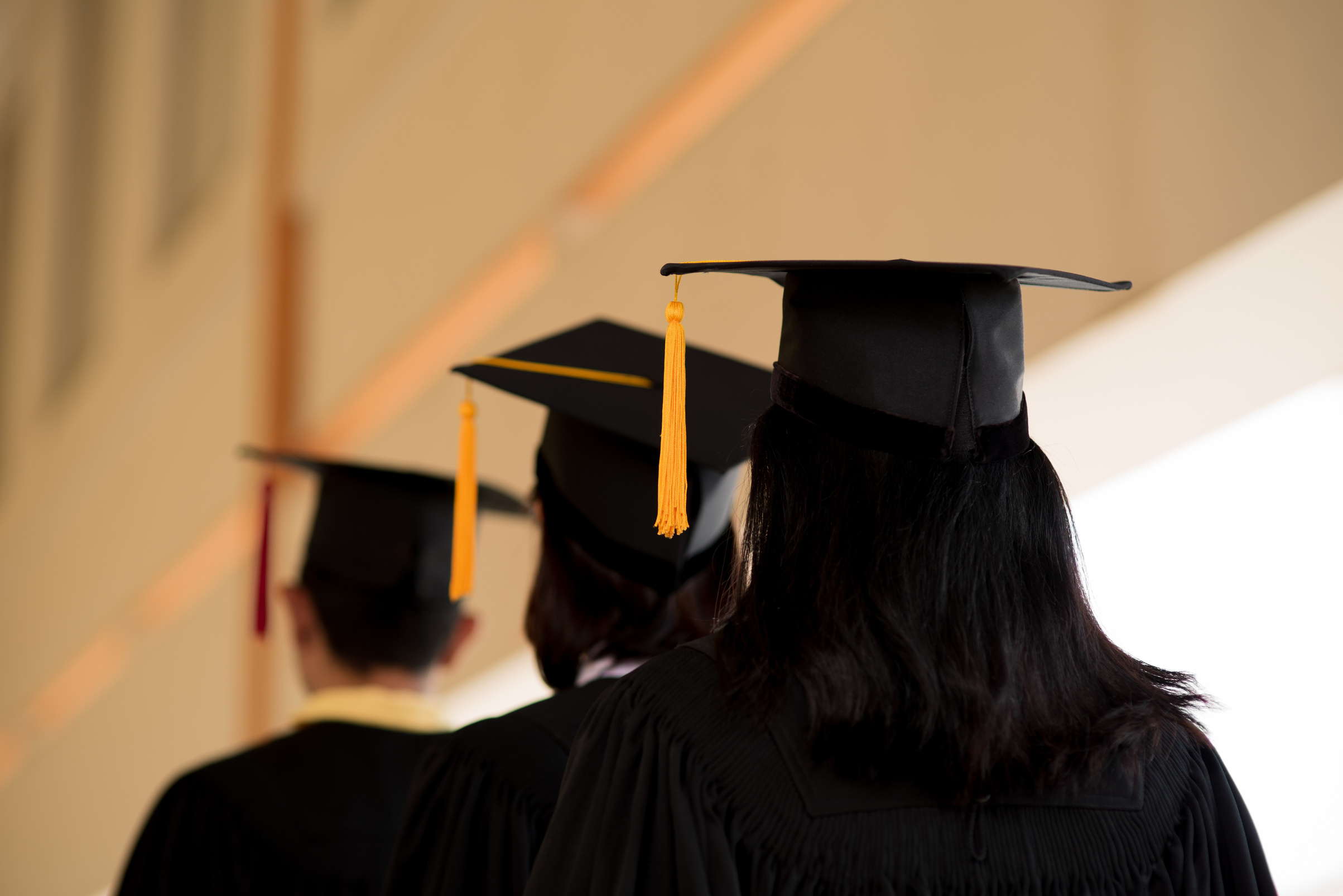 Black graduates wear black suits on graduation day at university.